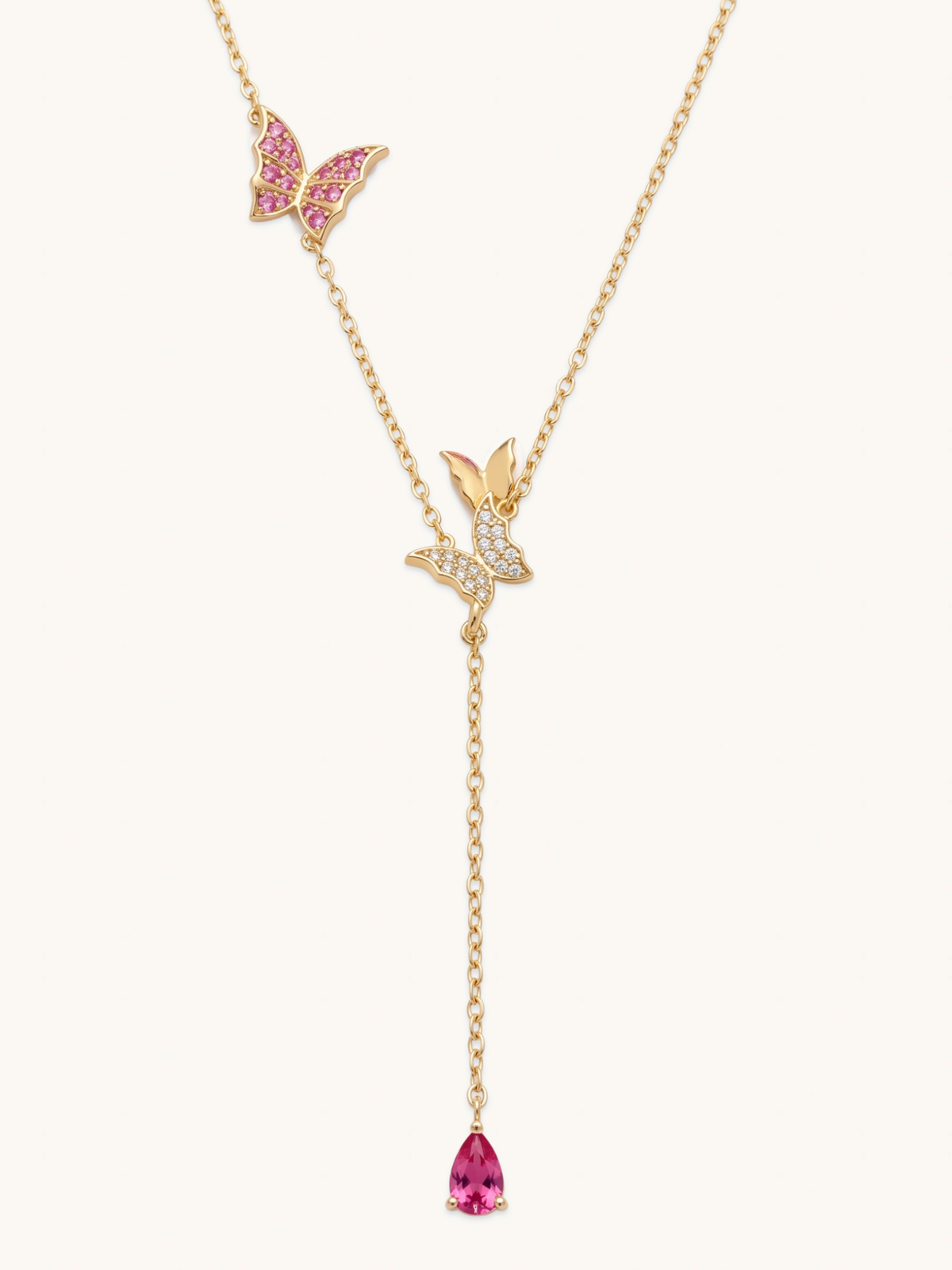 The Jewels Jar Astrid lariat necklace in 18k gold plated sterling silver with pink butterfly charms and a pink pear cut drop