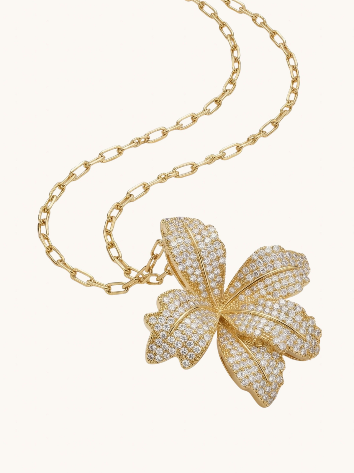 Close up of the gold Orchid Bloom pendant showing the sculpted pave petals