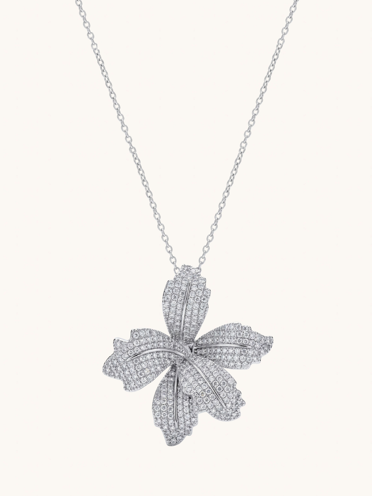 The Jewels Jar Orchid Bloom necklace, a pave cubic zirconia orchid pendant on a sterling silver chain