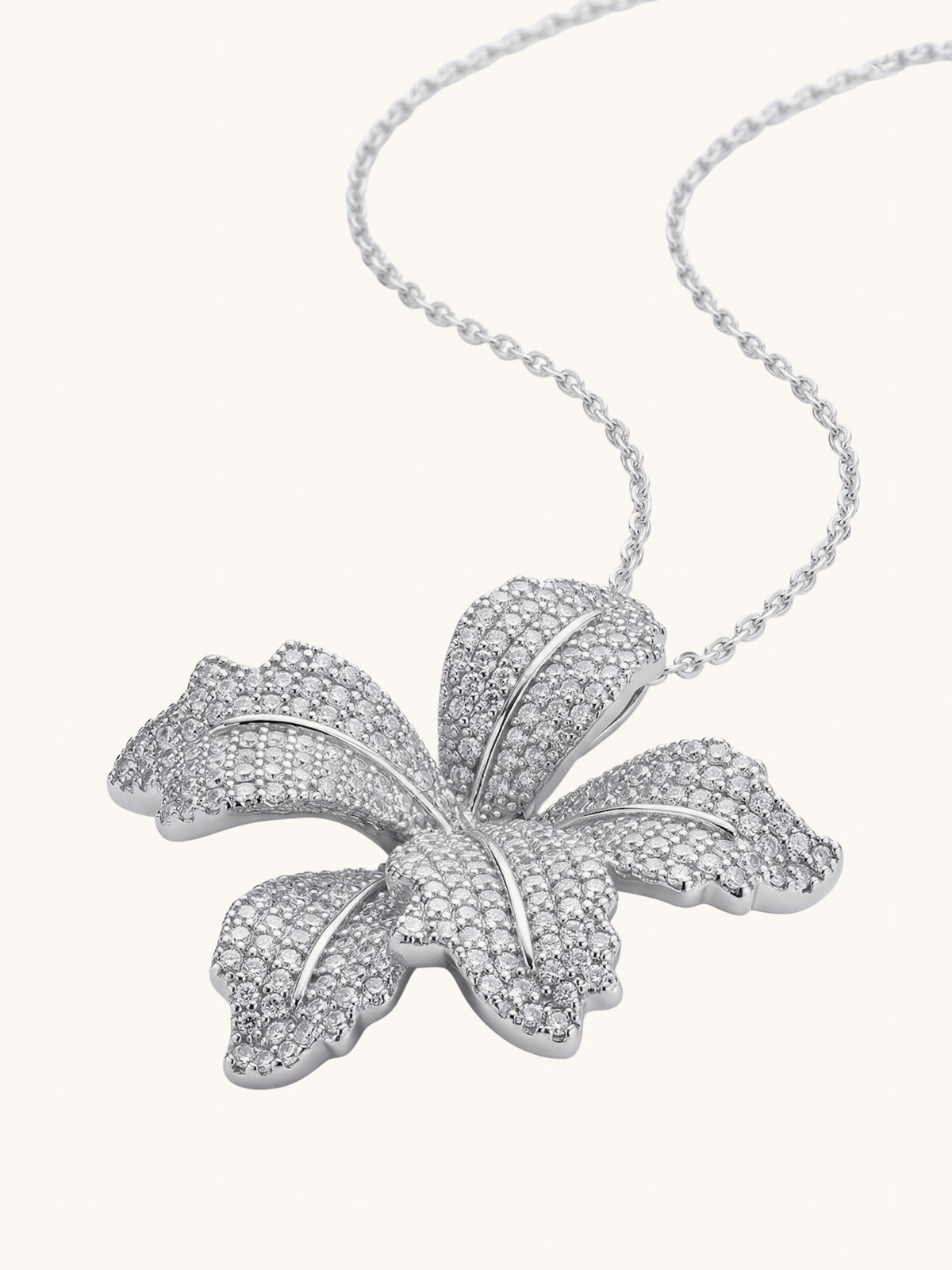 Close up of the Orchid Bloom pendant showing the pave petals in silver