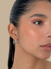 Close up of the Carla claw earrings on the ear with a sleek pulled back hairstyle