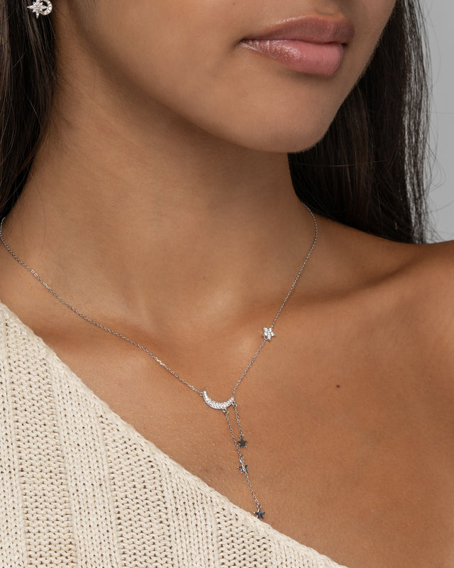 Close-up of the Alia Lariat Necklace in silver showing the pave moon and star drop