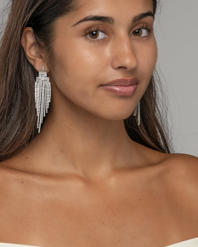 Model wearing the Elise waterfall fringe earrings, three quarter view
