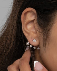 Close up of the Jia star earring on the ear in sterling silver