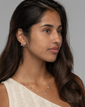 Model wearing the Jia star earrings in silver, three quarter view