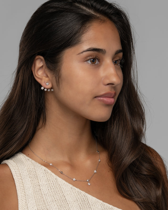 Model wearing the Jia star earrings in silver, three quarter view