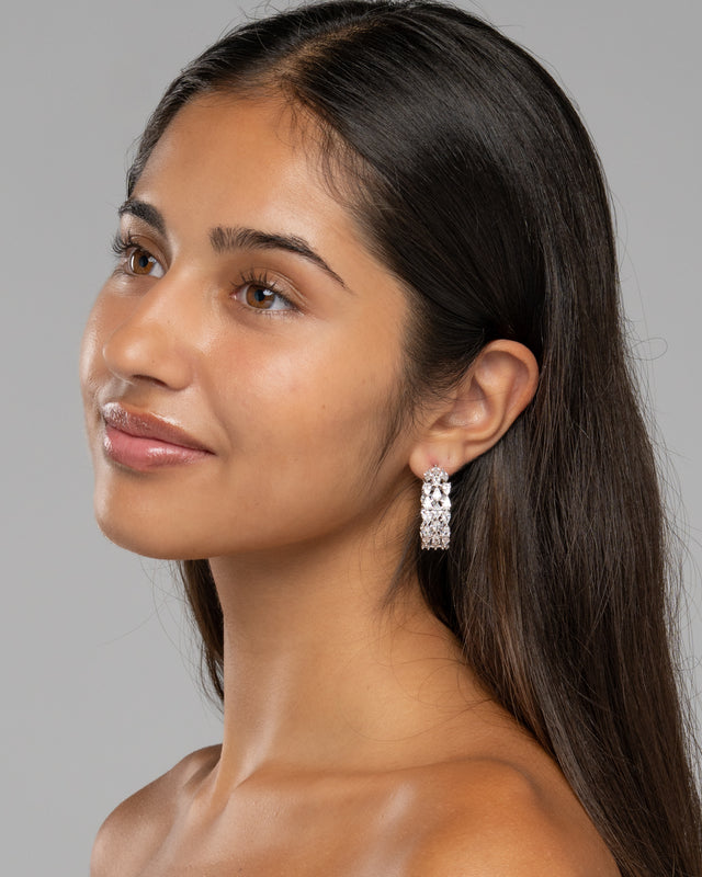 Side view of the Lustra pave hoop earrings worn on the ear