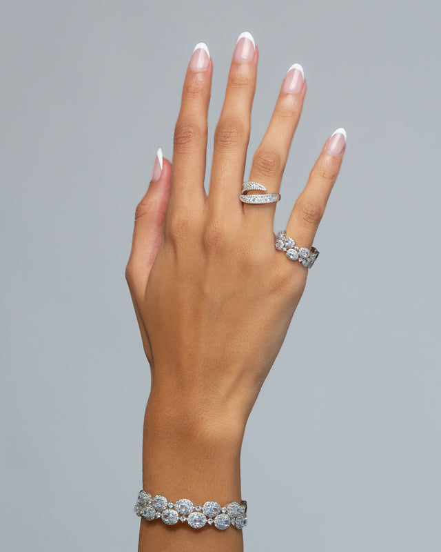 Jane open ring worn on the hand alongside a cubic zirconia bracelet