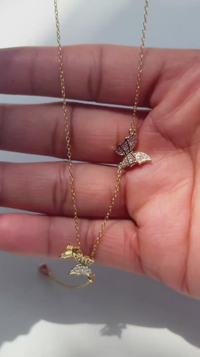 Video of the Astrid lariat necklace in 18k gold plated sterling silver with butterfly charms and a pink pear cut drop