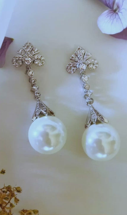 Video of the Perlina pearl dangle earrings with a cubic zirconia crown and round pearl drop