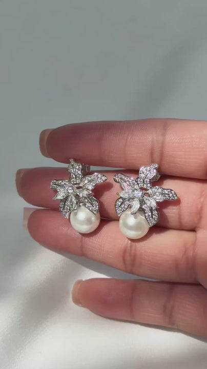 Video of the Cattleya pearl earrings, cubic zirconia orchid studs with a shell pearl drop