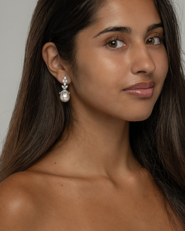 Model wearing the Rania pearl dangle earrings, three quarter view